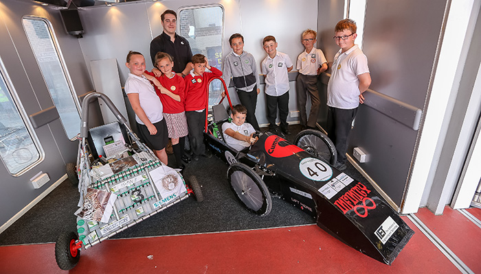 School children with a racing car